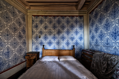 Letto nella camera blu della casa nel bosco