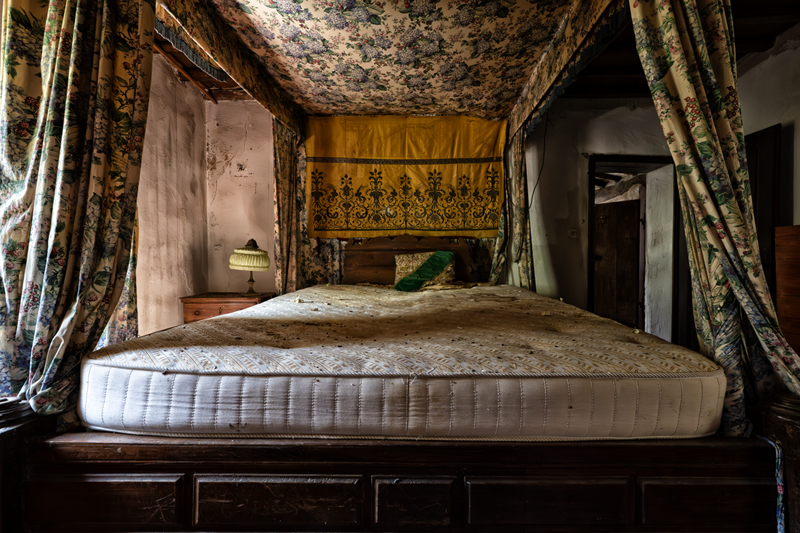 Letto a baldacchino con materasso nel casolare abbandonato